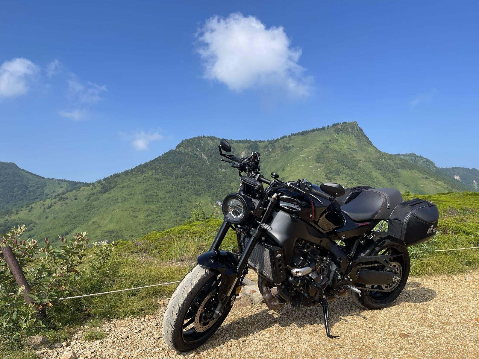 The XSR900 parked at Kenashi Pass with green mountains behind